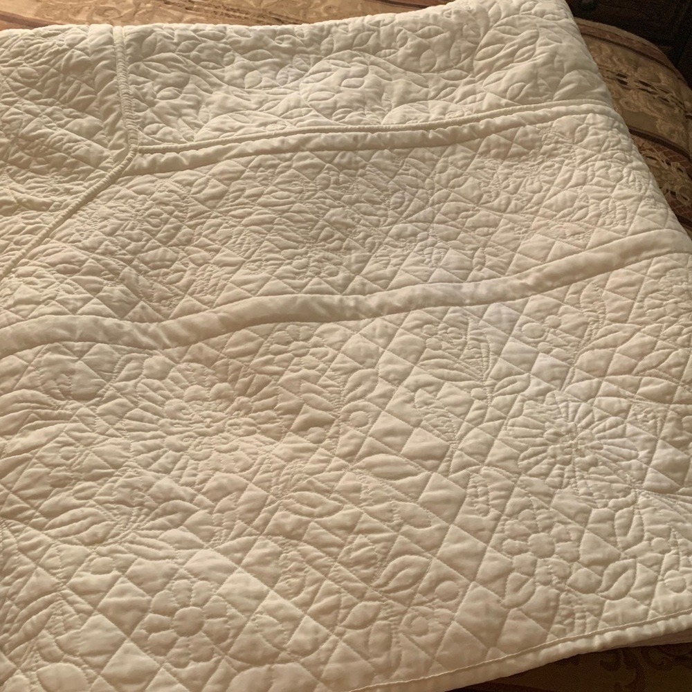 A light beige floral quilt by Martha Stewart Collection